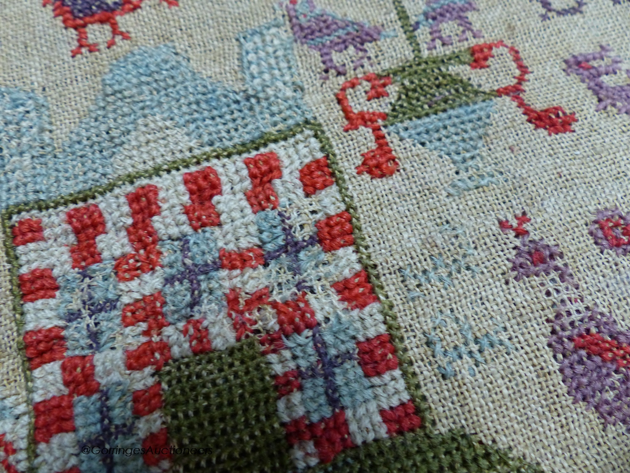 A cross stitch sampler, 41cm high, 29.5cm wide